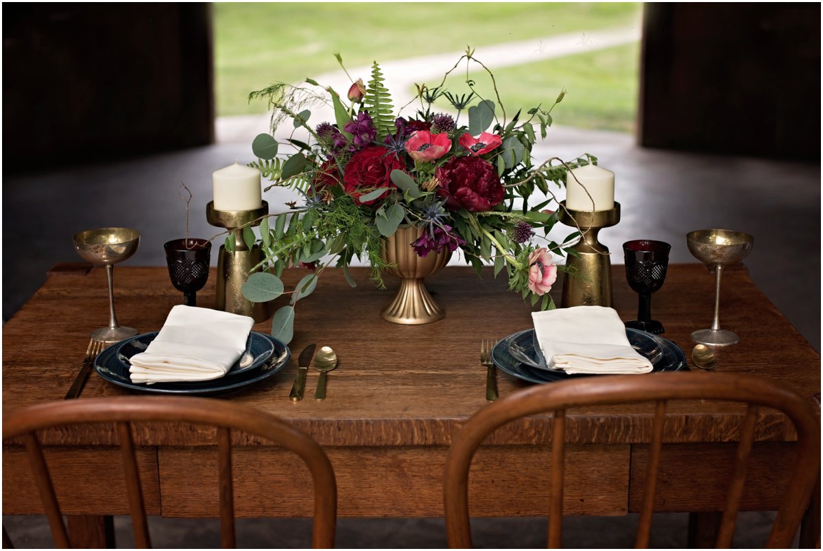 simple table setting with crimson floral centerpiece