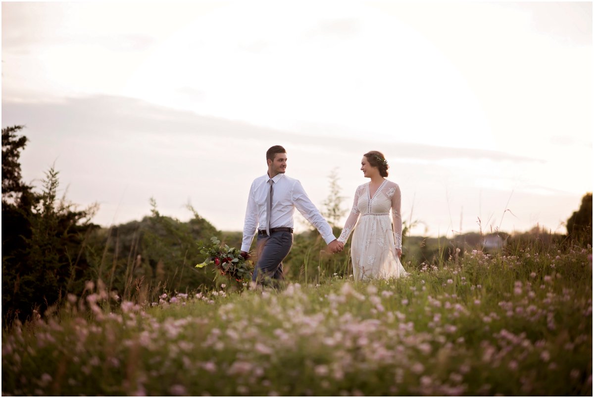 hipster wedding couple on the prairie at sunset