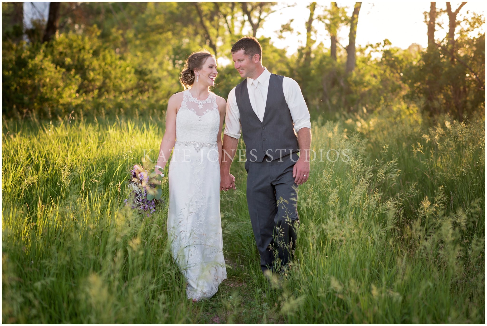 bride groom laughing in field on wedding day