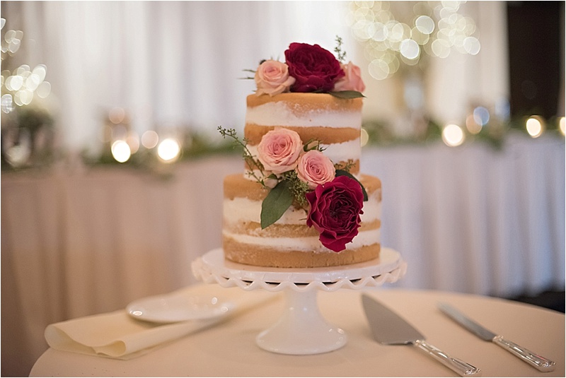 blush and burgundy floral accent on rustic wedding cake