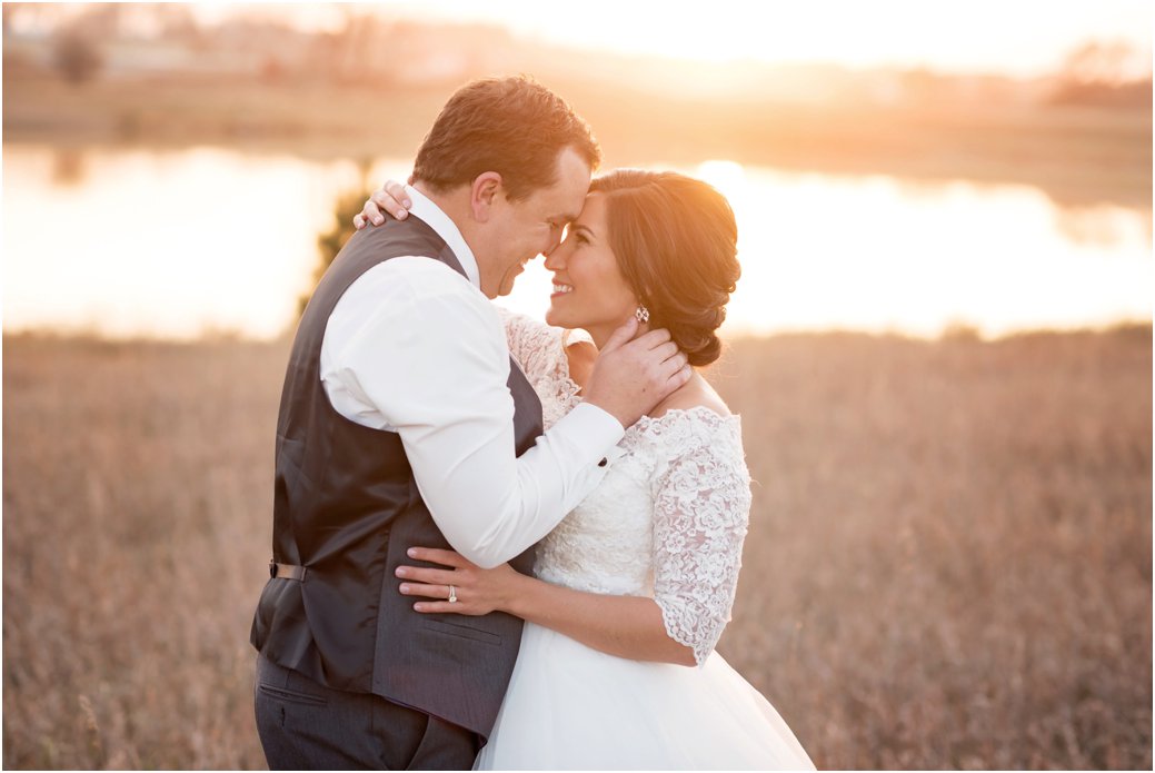 bride and groom in romantic embrace at sunset