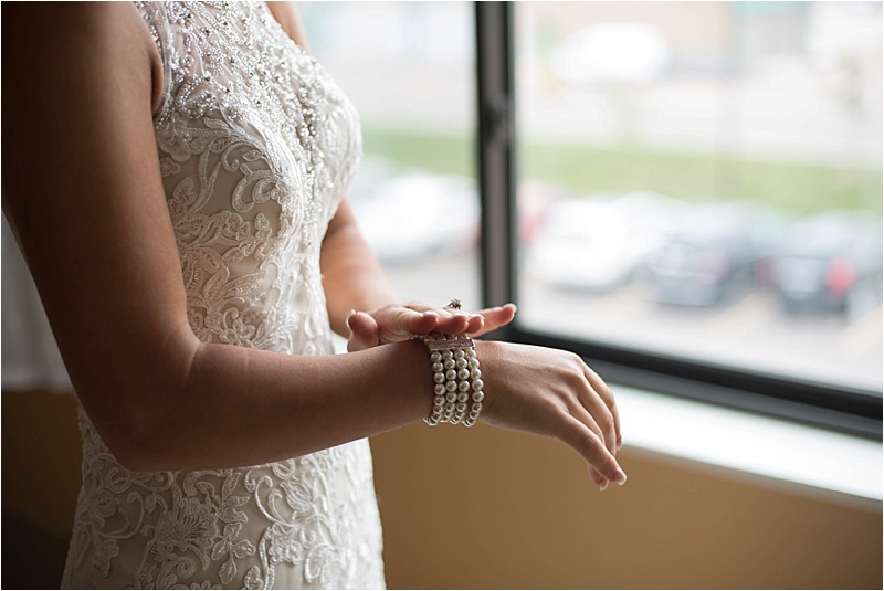 ivory lace wedding dress with pearl bracelet