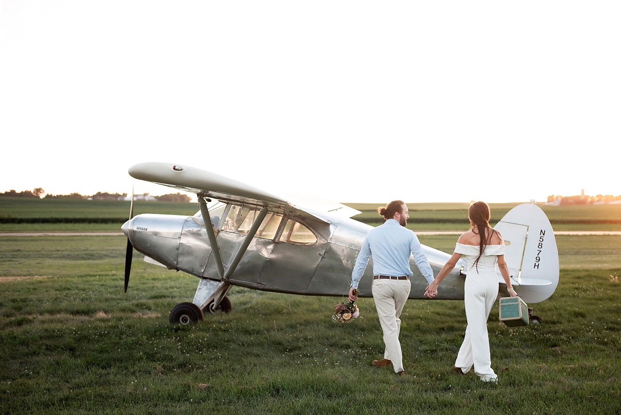 bride and groom getaway in vintage piper airplane