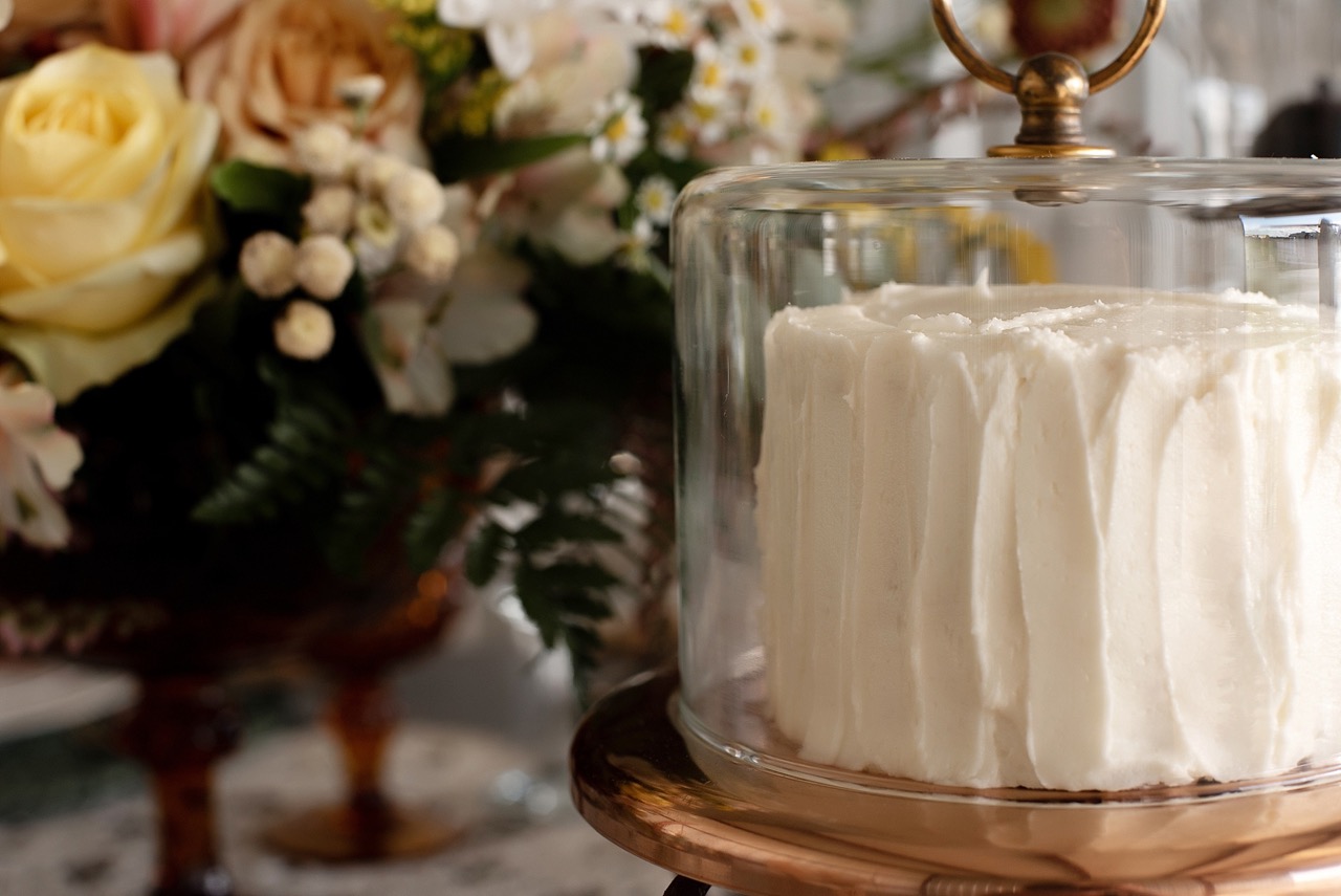 textured white cake in vintage cake stand