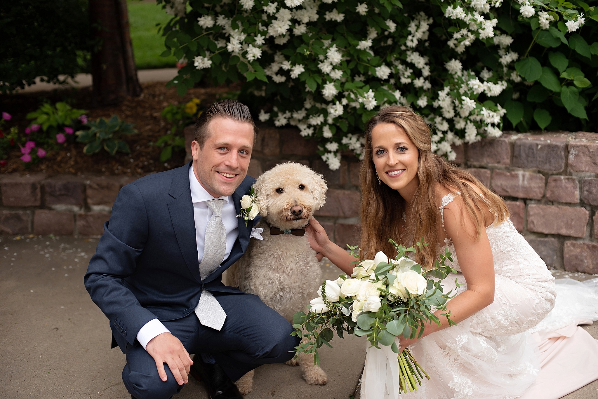 bride and groom with their best puppy