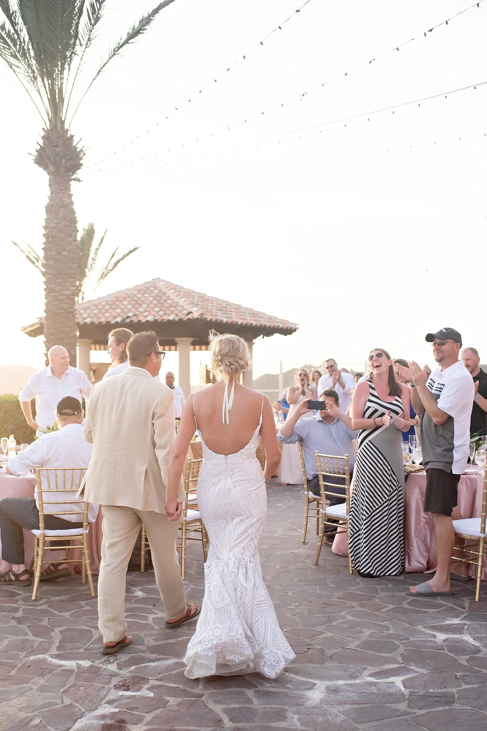 bride and groom enter rooftop poolside wedding reception destination pueblo bonito sunset beach mexico