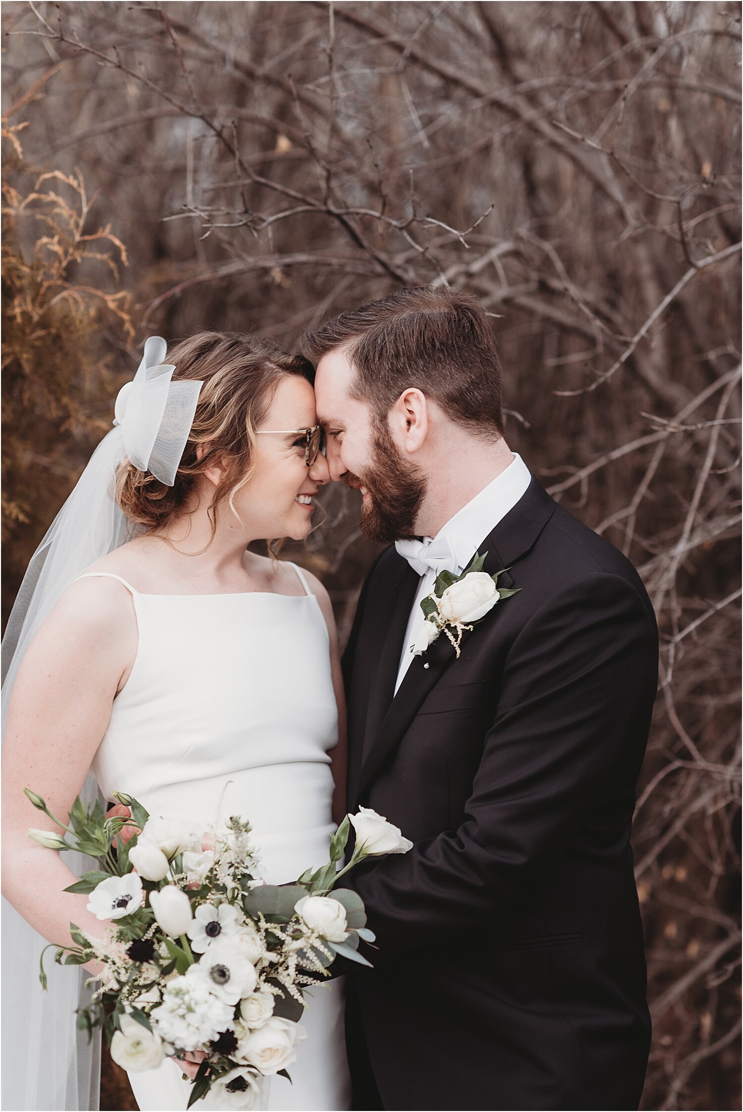 bride and groom cuddle for portraits spring wedding