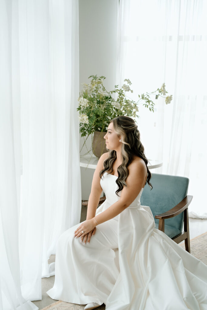 Bride finishing details before ceremony at The Atrium at Blue Haven