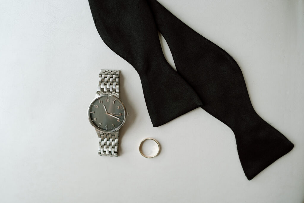 Groom details arranged inside The Atrium at Blue Haven wedding venue